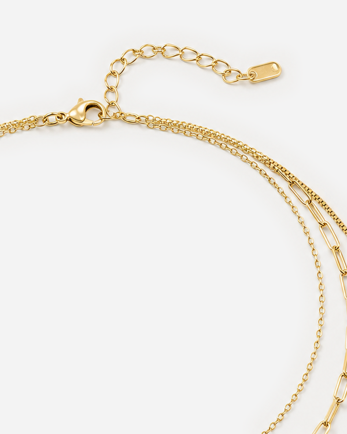 Adira Layered Necklace — triple-chain lobster clasp, oval extender and flat end-tag closure detail
