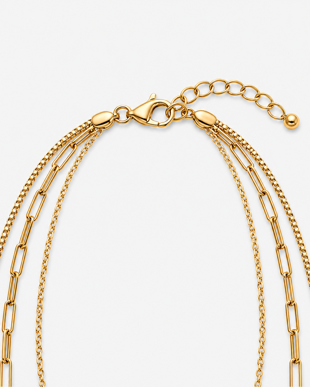Gold lobster clasp, oval-link extender and three-layer chain closure detail