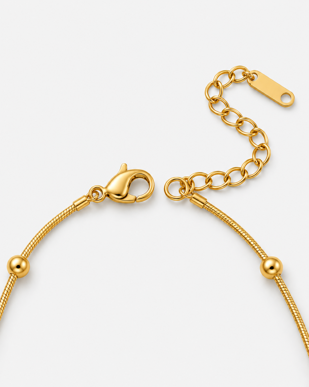 Delja Beaded Snake Chain Necklace — 09 — Gold — lobster clasp, oval extender and rounded-rectangle terminal macro