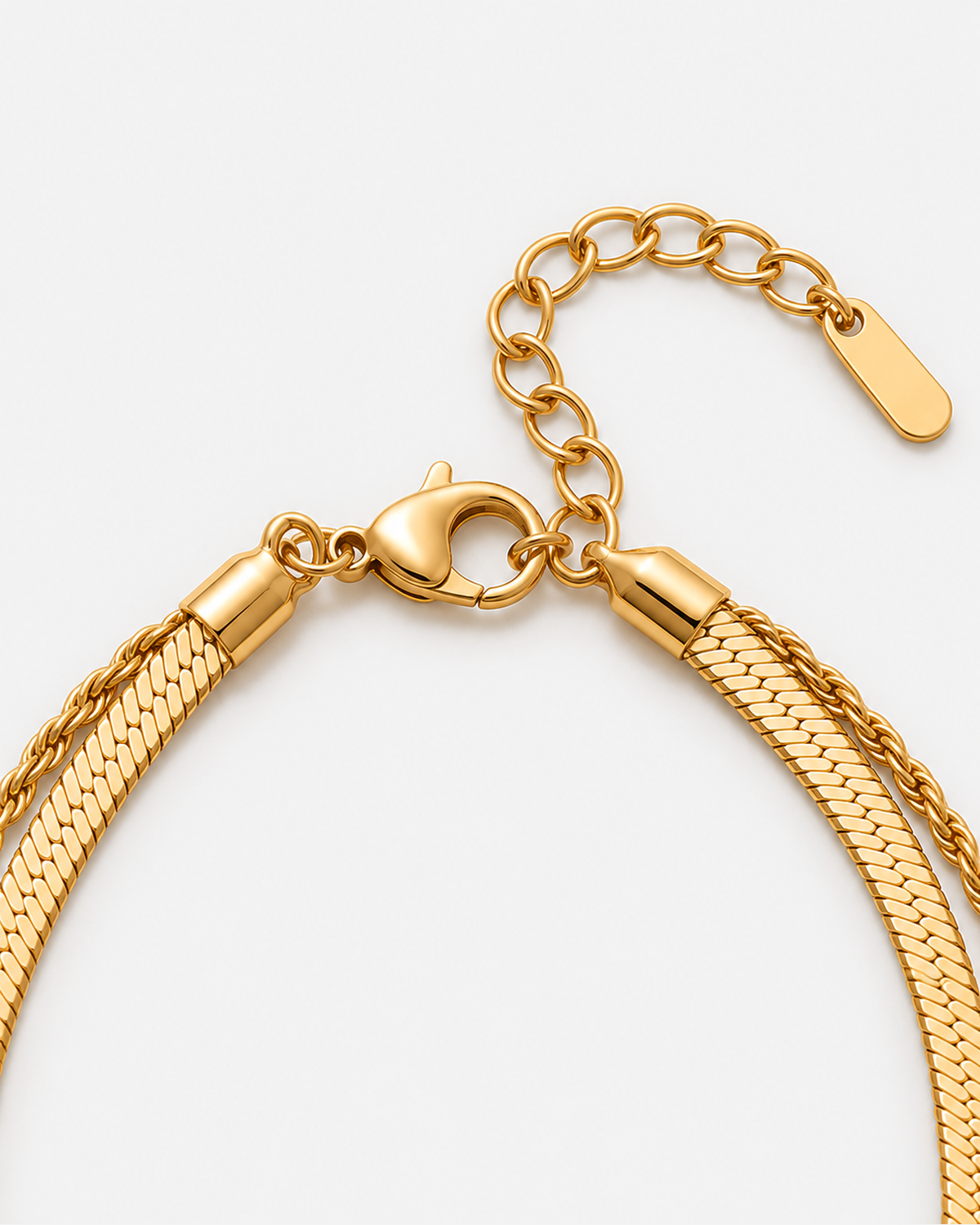 Gold lobster clasp, extender and layered herringbone and rope-chain closure detail