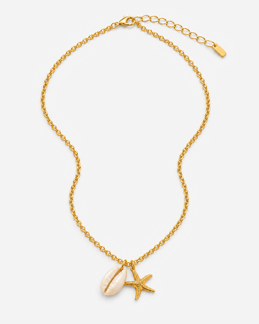 Callie gold-tone necklace with a white shell-shaped charm and textured starfish pendant
