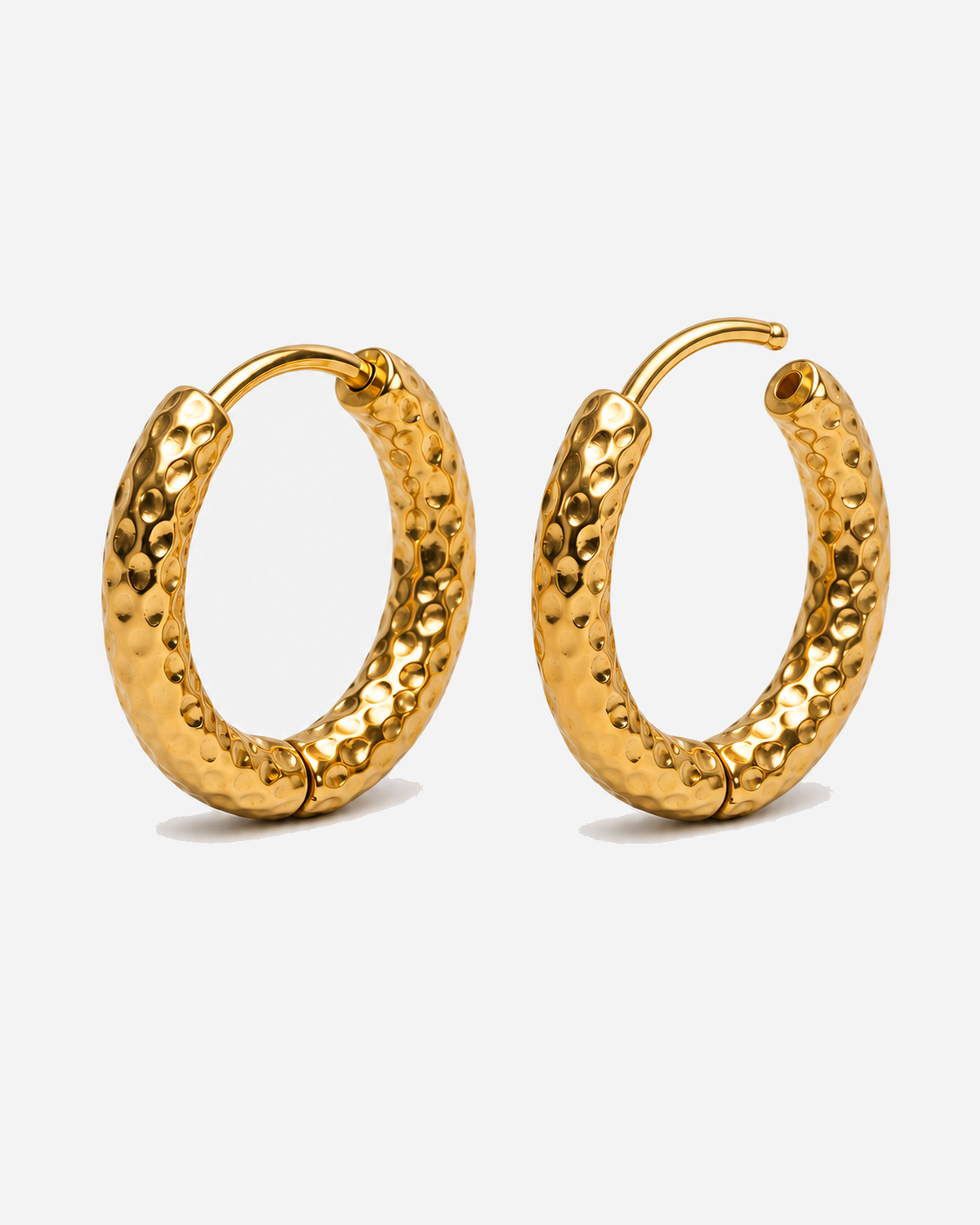 Pair of gold-tone Valentina hoops showing a dimpled hammered surface