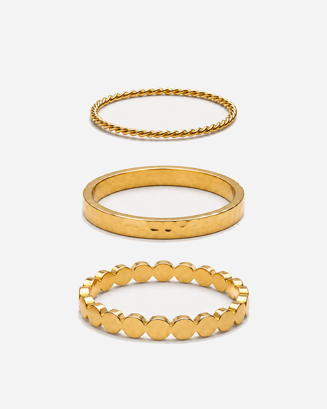 Three gold-tone Thalia rings with distinct band designs, shown separately.