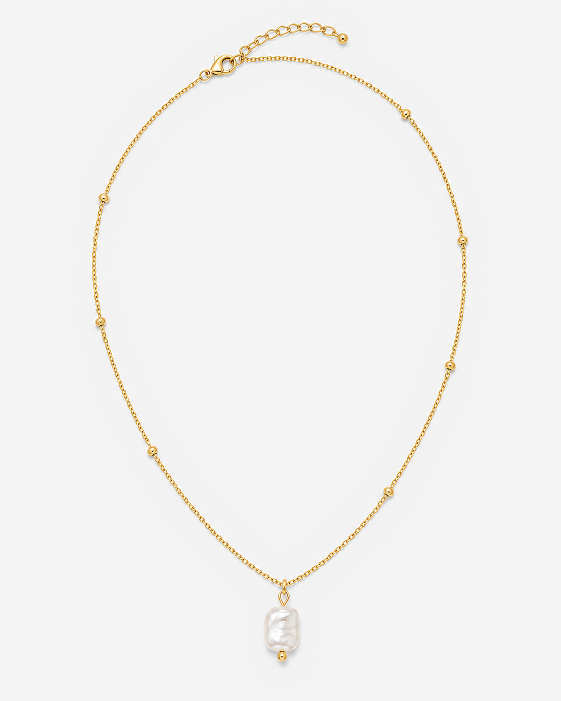 Alara necklace laid flat with its chain, clasp and extender visible