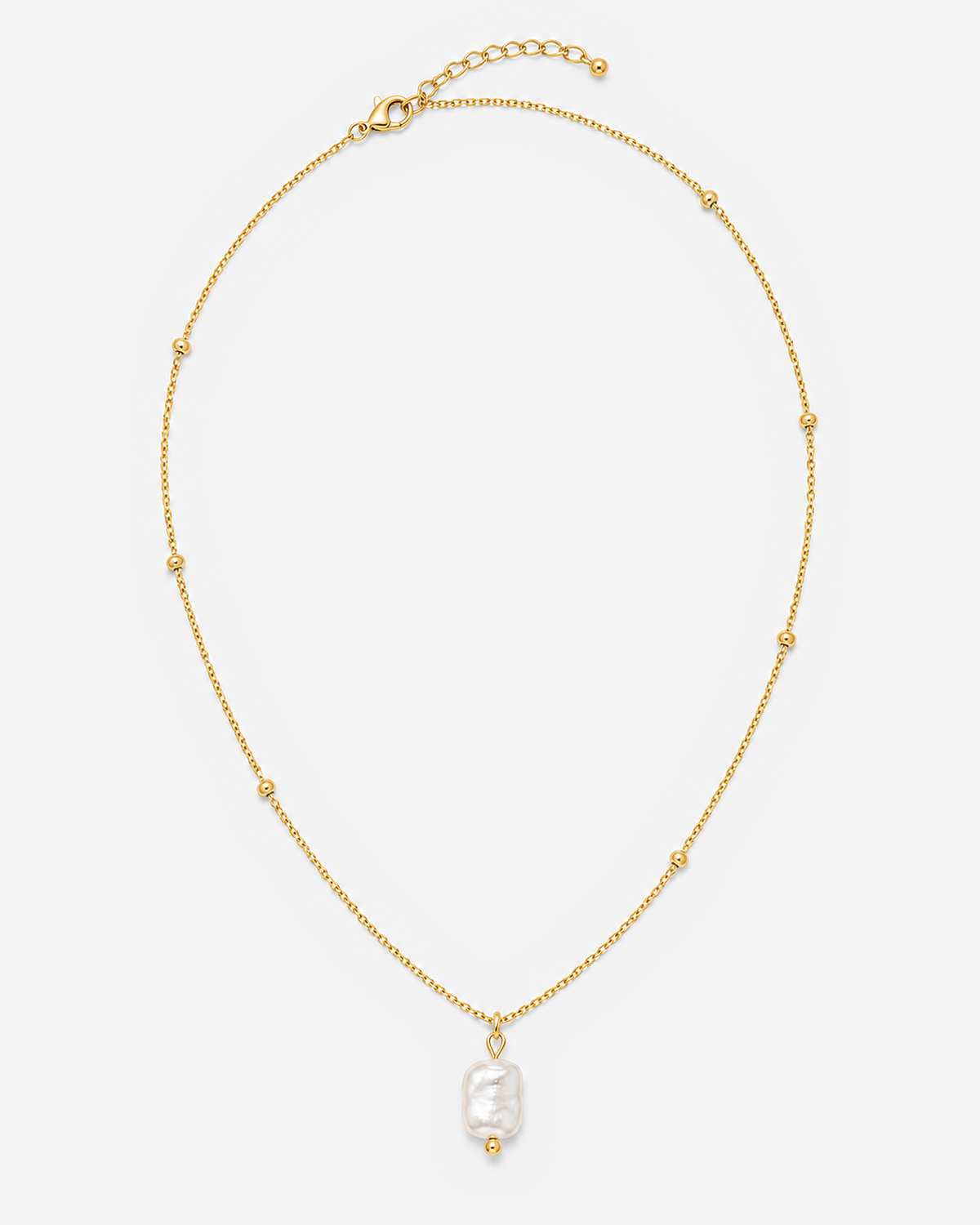 Alara necklace laid flat with its chain, clasp and extender visible