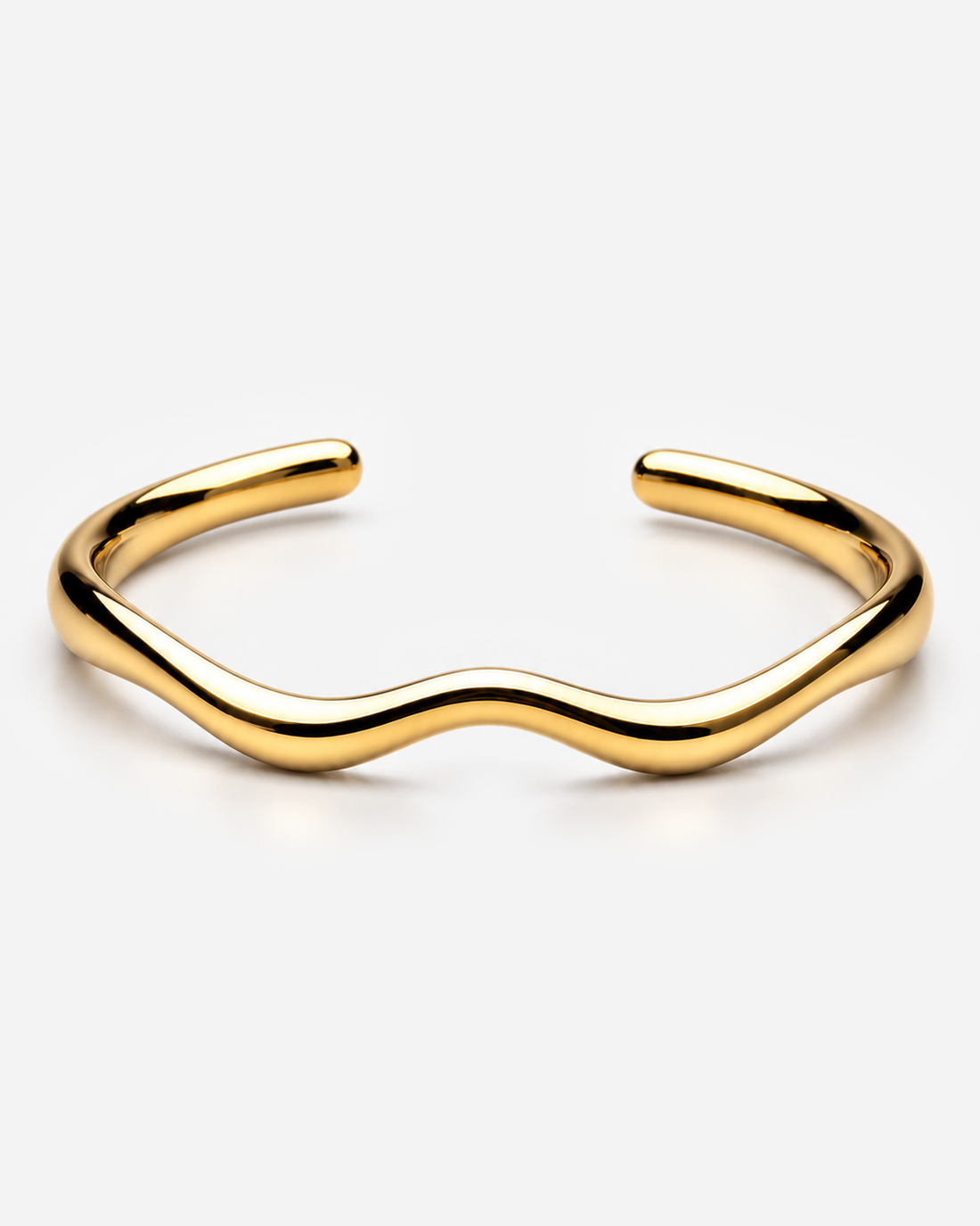 Belen gold-tone open cuff showing its shaped inner space and rounded ends