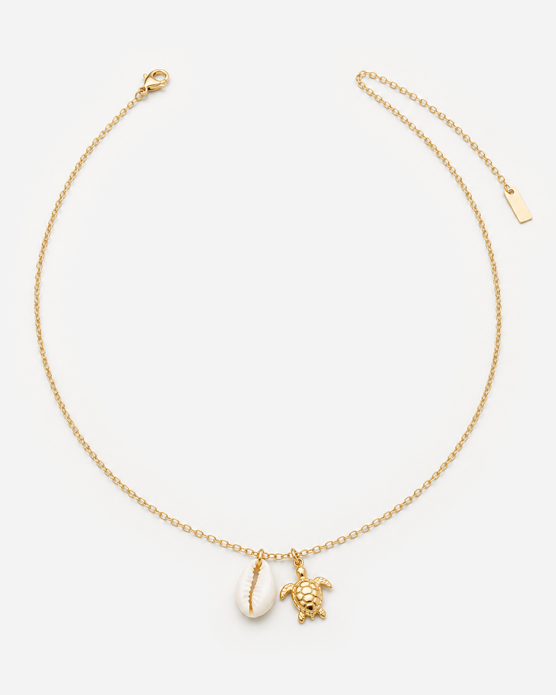 Malia gold-tone necklace with white shell-shaped and textured turtle charms.