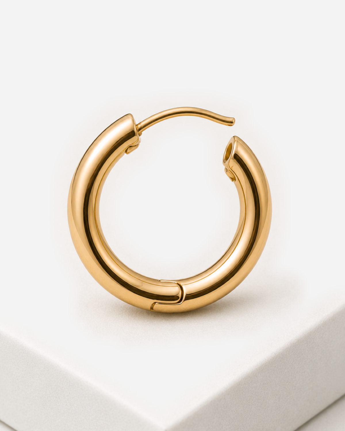 Open gold-tone Vienna hoop showing its curved post, catch and lower hinge