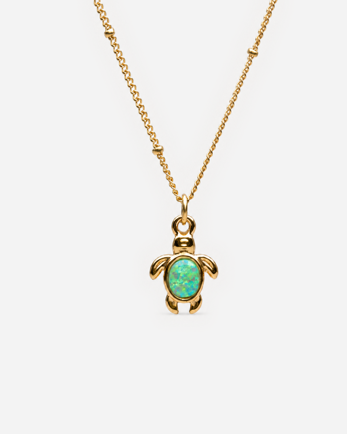 Celine gold-tone turtle pendant with a blue-green simulated-opal centre