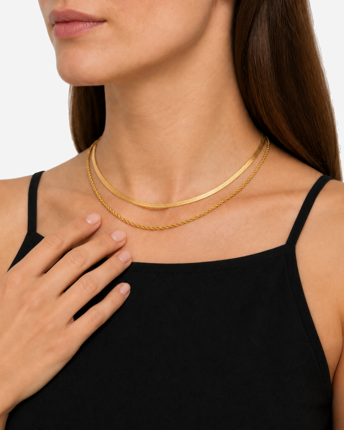 Nerina gold-tone layered chains above a black narrow-strap neckline