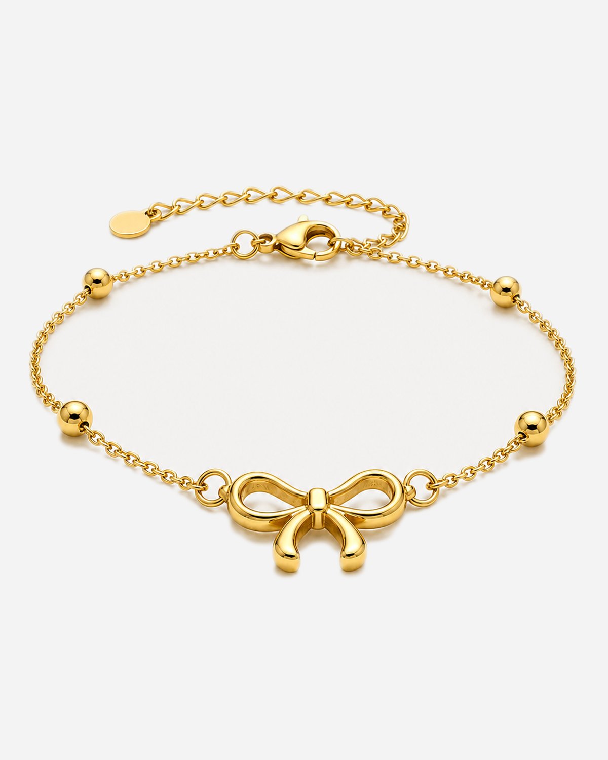 Brodie gold-tone chain bracelet with a bow motif and round accents