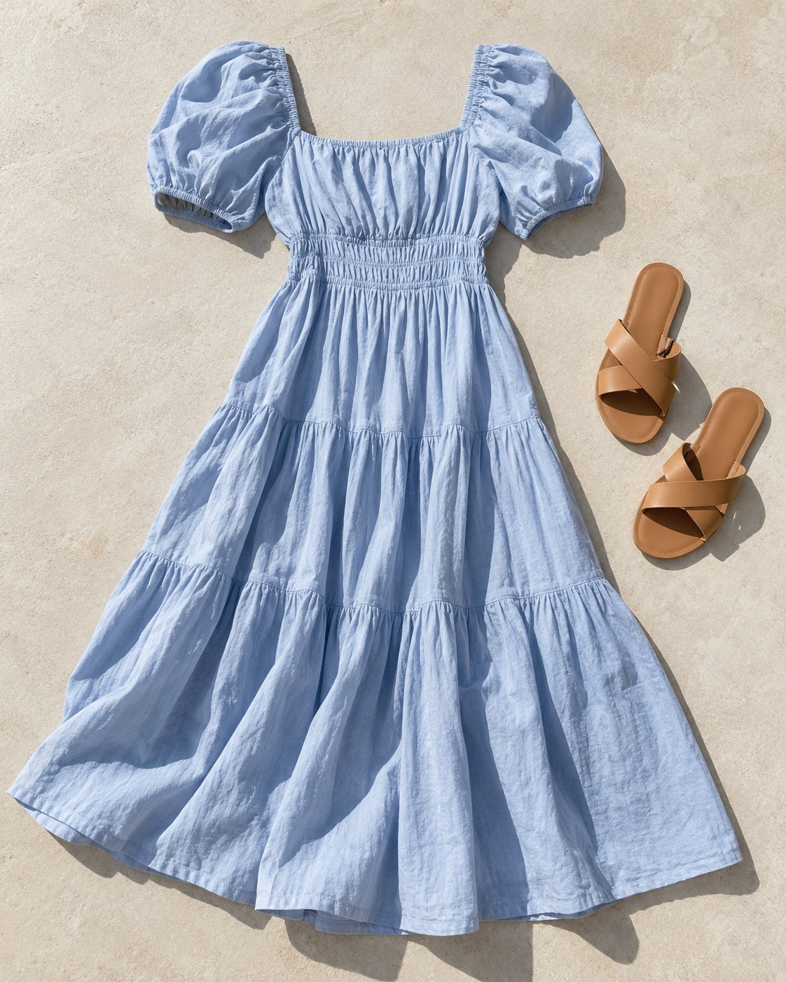 Illustrative light-blue summer dress and flat sandals for Christmas lunch styling inspiration.