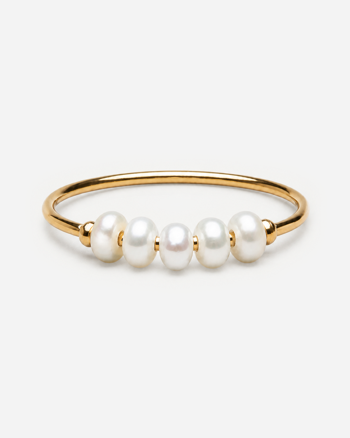 Bronte gold-tone ring with five smooth white oval accents across the front of the band.