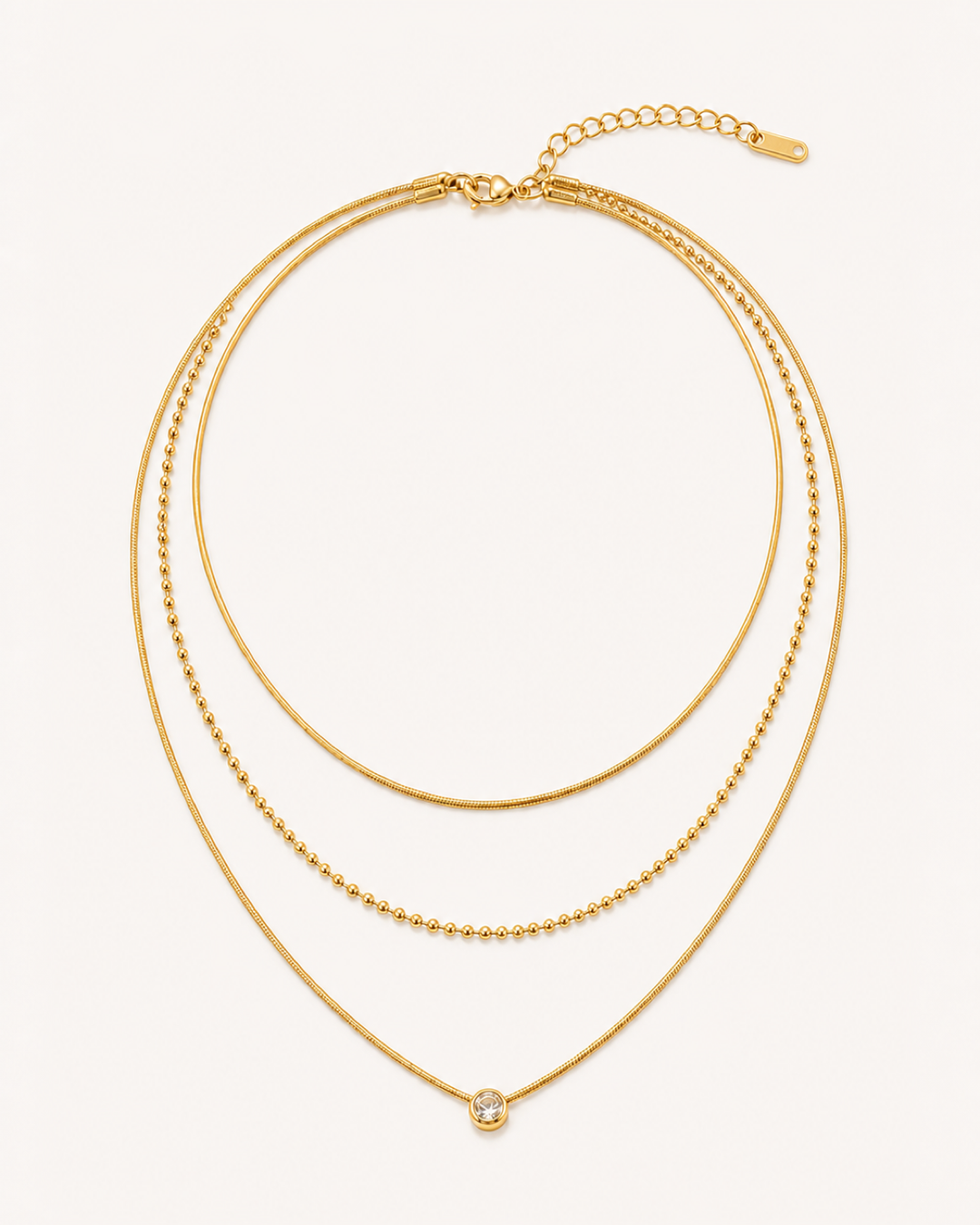 Alyrah Layered Crystal Necklace — sharp warm off-white product hero