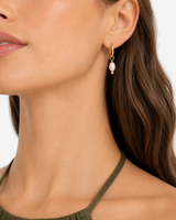 Jolie Pearl Huggie Hoops — model three-quarter view