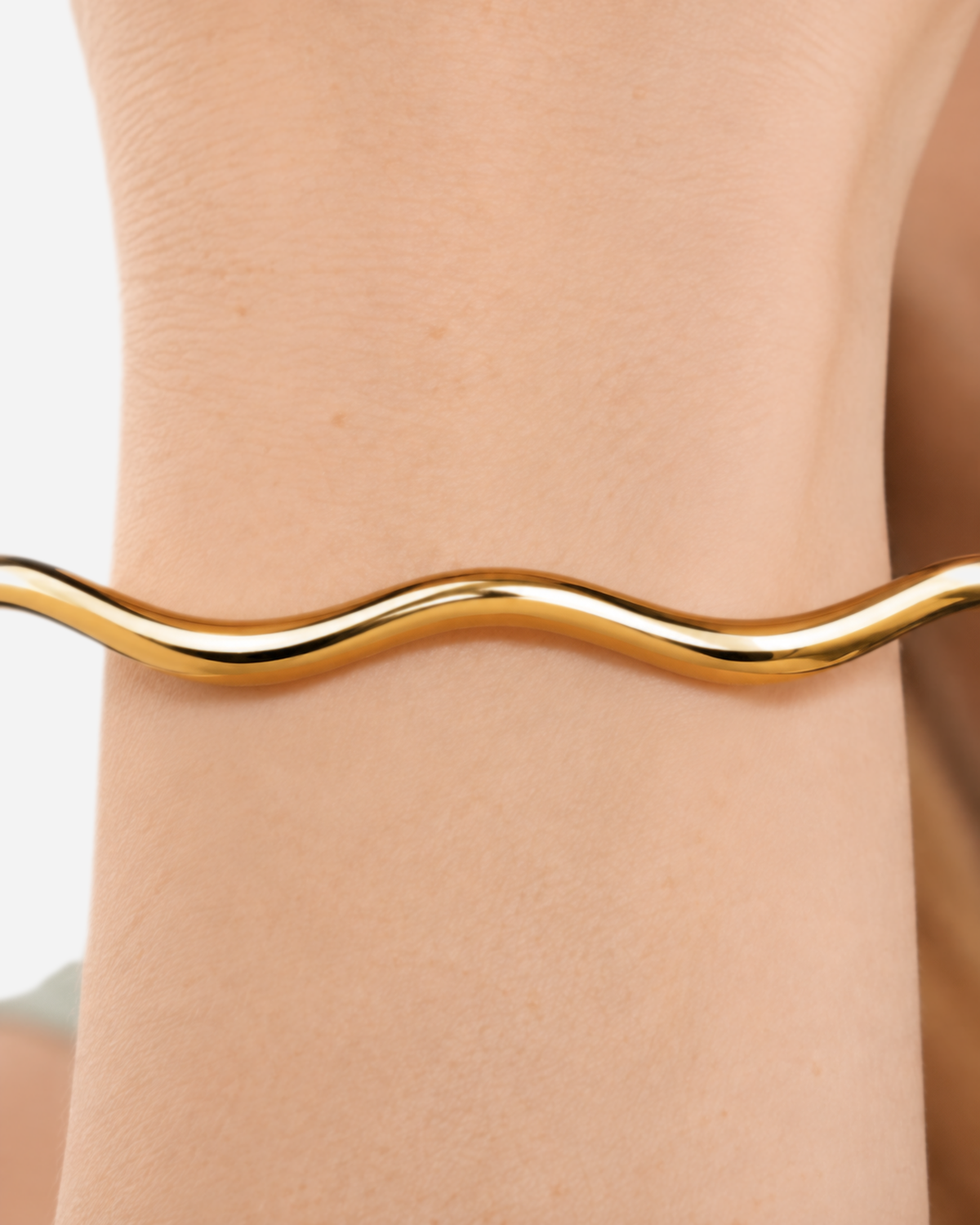 Belen Cala Cuff — Gold — outer-wrist double-wave close-up