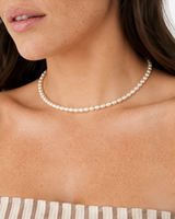 Elara Freshwater Pearl Choker — 06 — Gold — dusty-plum/taupe outfit — wider upper-torso view