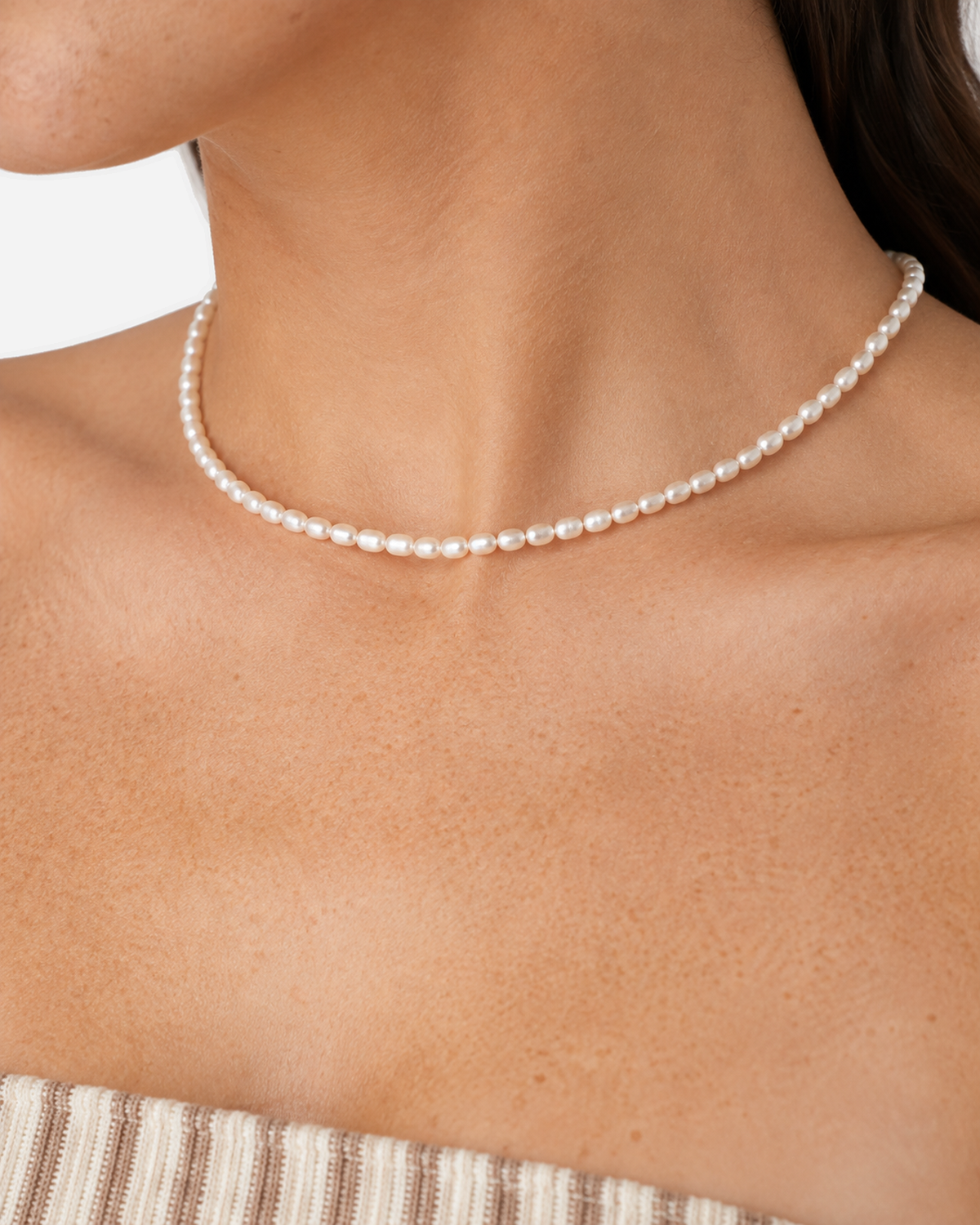 Elara white beaded choker in a wider collarbone wearing view