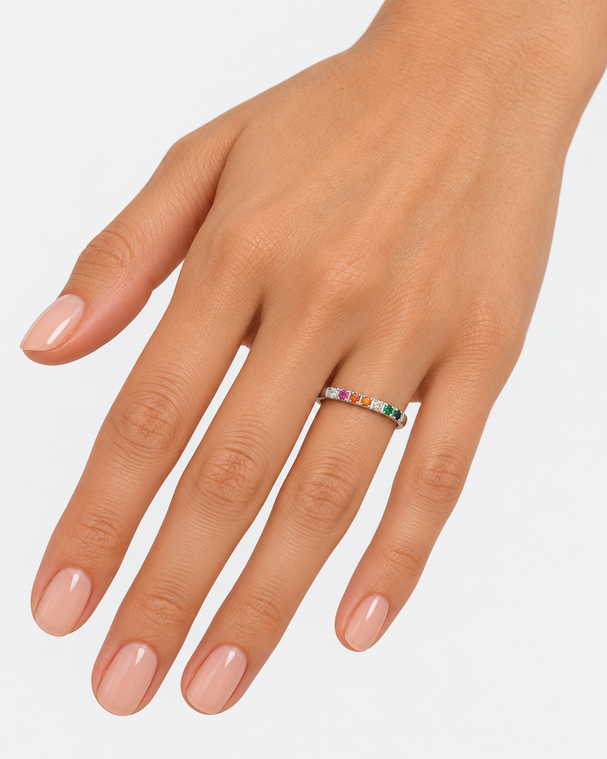 Silver-tone multicoloured ring worn with the arms crossed