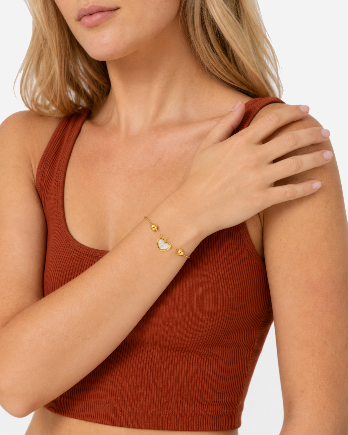 Muriel Heart Shell Bracelet — 07 — Gold — sea-glass/ivory outfit — hand on shoulder
