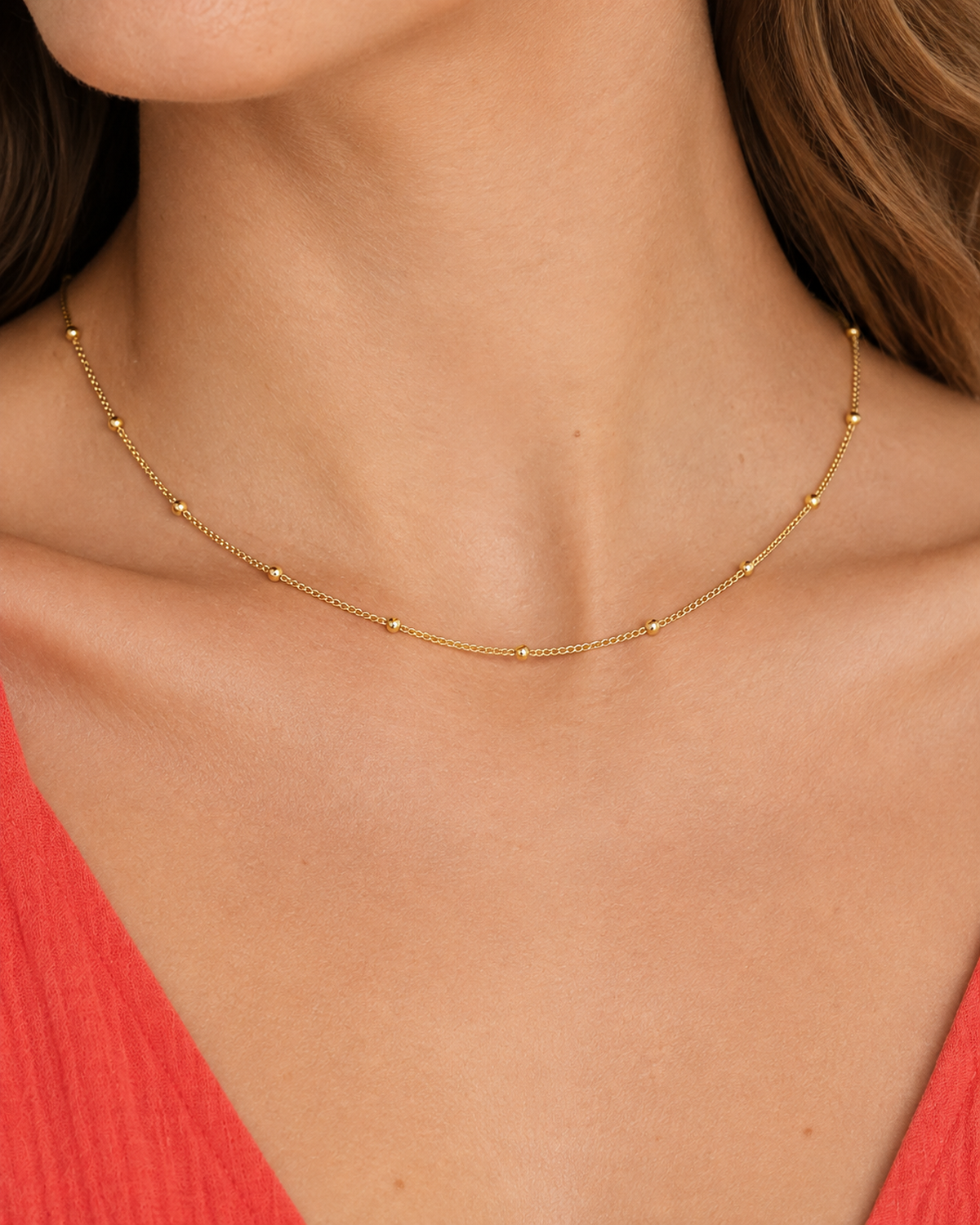Delja Beaded Necklace — Gold — close-up model wearing view