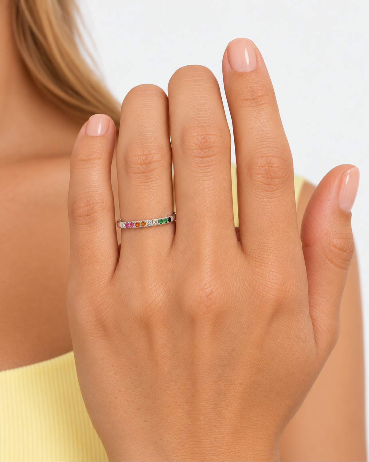 Close hand detail of the silver-tone ring and multicoloured accents