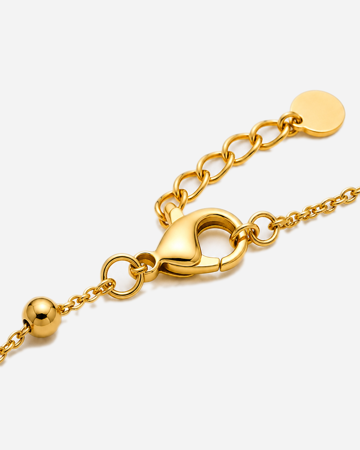 Brodie Bow Tie Bracelet — 09 — Gold — lobster clasp, oval extender and circular tag macro