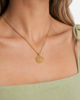 Marisol Golden Sun Necklace — 24 — Gold — shell-white open-collar resort shirt — model wide editorial