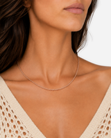 Kaia Rope Chain Necklace — 25 — Rose Gold — dark-teal/shell-pink outfit — hand-led wearing close-up