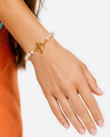 Dara Pearl Bracelet — 04 — Gold — apricot/seafoam outfit — toggle wrist