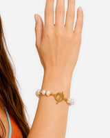 Dara Pearl Bracelet — 05 — Gold — apricot/seafoam outfit — upright hand