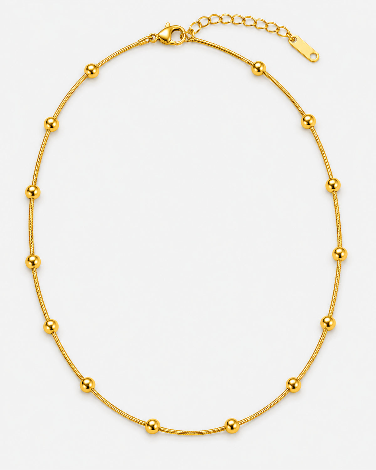 Delja gold-tone necklace with a smooth fine chain and spaced round beads