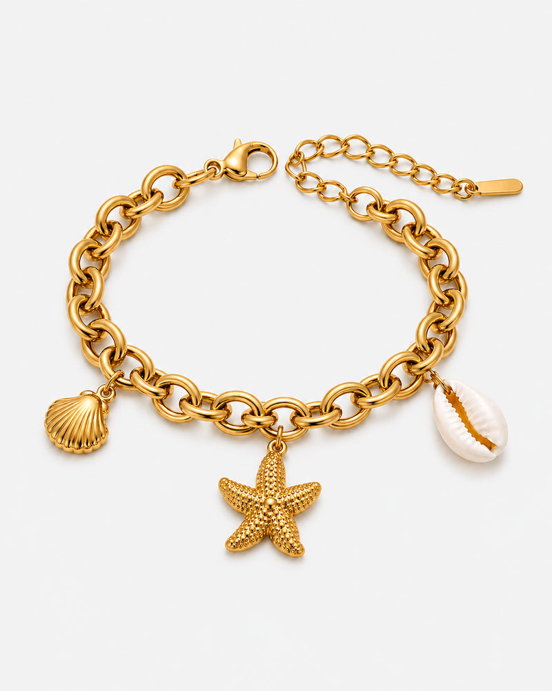 Jenna gold-tone link bracelet with shell and starfish motifs, a white shell-shaped charm and extender chain