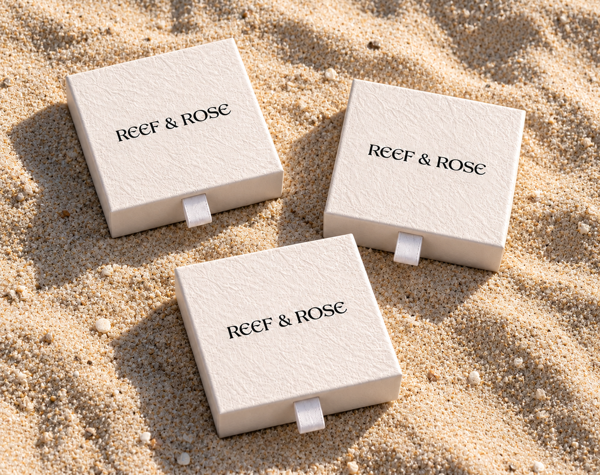 Reef & Rose presentation boxes on sand
